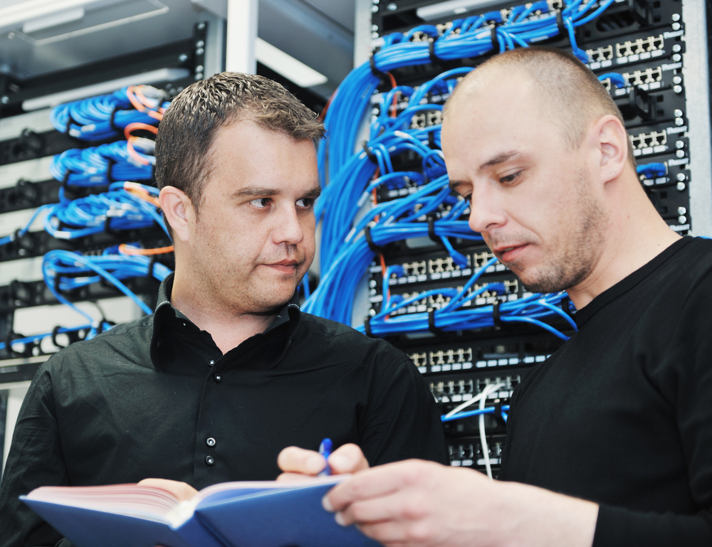it engineer in network server room solving problems and give help and support it engineer in network server room solving problems and give help and support
